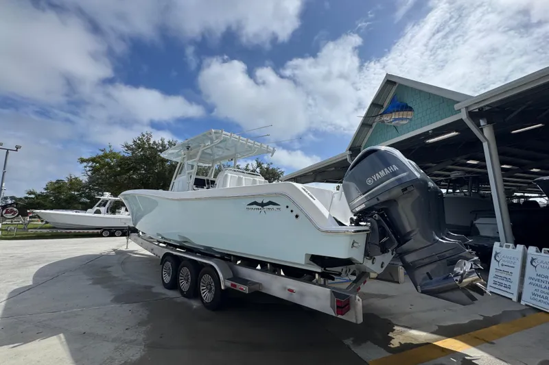  Yacht Photos Pics 2019 Invincible 39 Open Fisherman boat with Yamaha engine on trailer, parked outdoors.