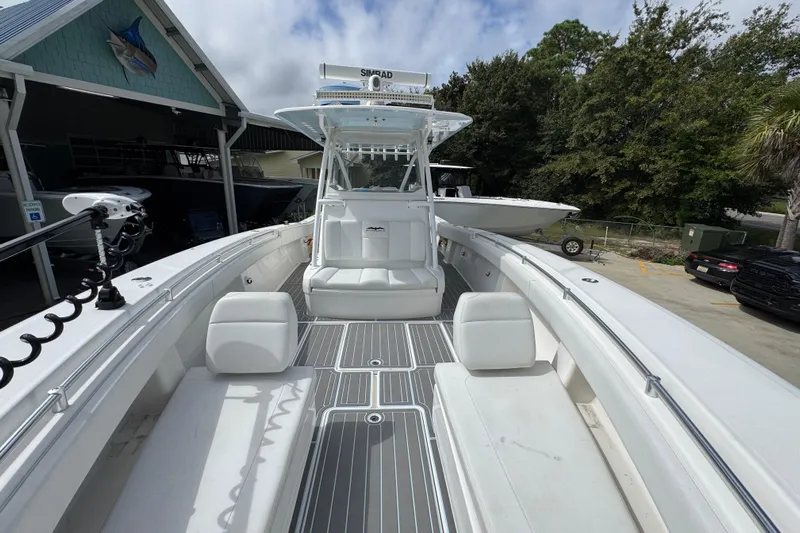  Yacht Photos Pics 2019 Invincible 39 Open Fisherman boat with spacious deck and seating, docked outdoors.