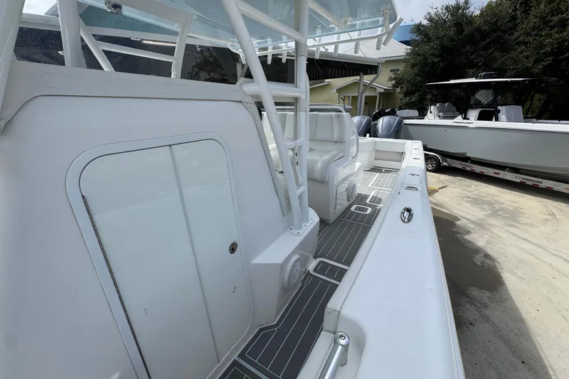  Yacht Photos Pics 2019 Invincible 39 Open Fisherman boat, white interior, docked with another boat nearby.