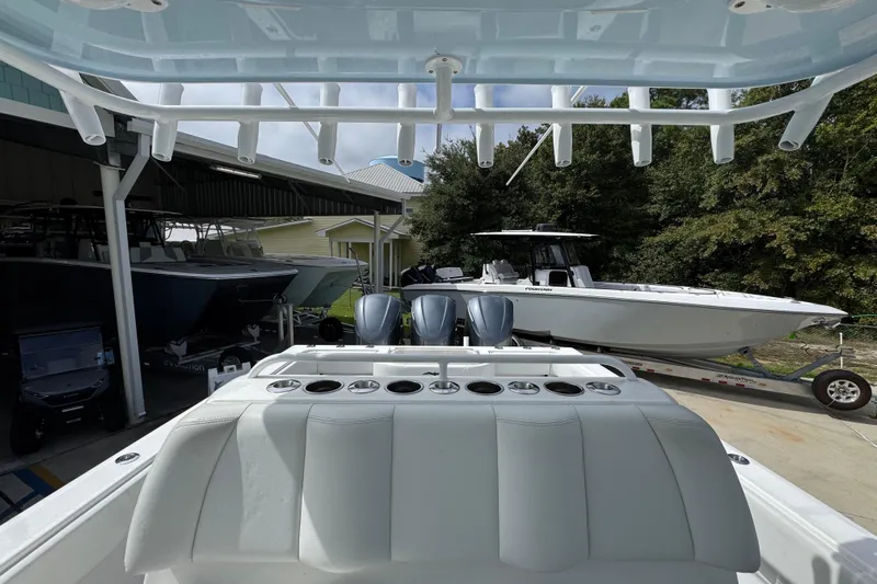  Yacht Photos Pics 2019 Invincible 39 Open Fisherman boat with triple engines, docked outdoors.