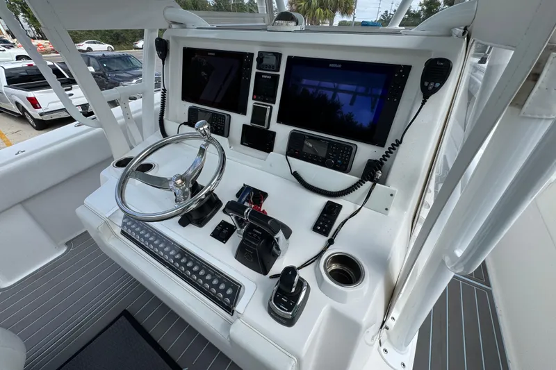 Yacht Photos Pics 2019 Invincible 39 Open Fisherman boat console with steering wheel and navigation screens.