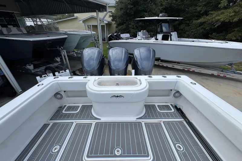  Yacht Photos Pics 2019 Invincible 39 Open Fisherman boat with triple engines, docked near other boats.