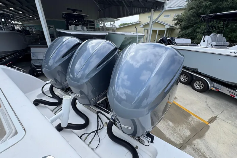  Yacht Photos Pics Triple outboard engines on a 2019 Invincible 39 Open Fisherman boat in a marina.