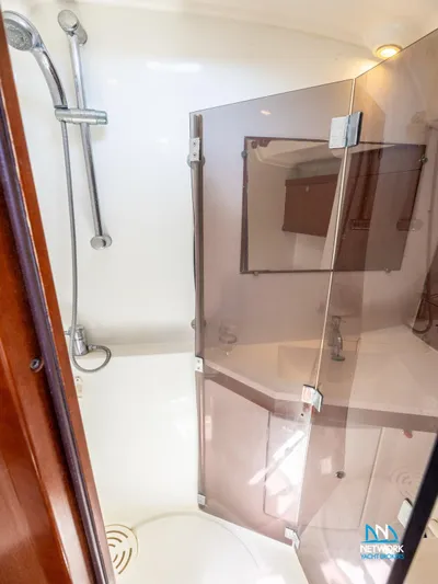  Yacht Photos Pics Shower area in 2011 Beneteau Oceanis 46 yacht with glass door and modern fixtures.