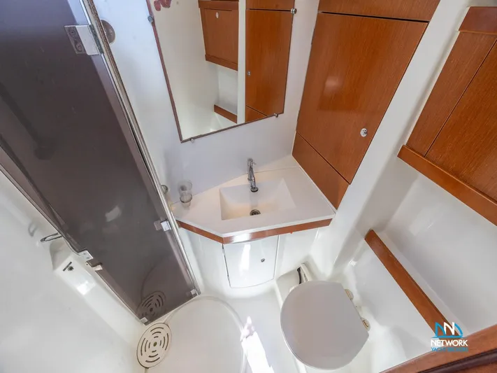  Yacht Photos Pics 2011 Beneteau Oceanis 46 bathroom with wooden cabinets, sink, and shower area.