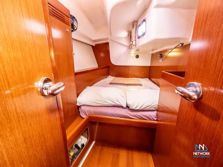  Yacht Photos Pics Cozy cabin interior of 2011 Beneteau Oceanis 46 sailboat with wooden finish.