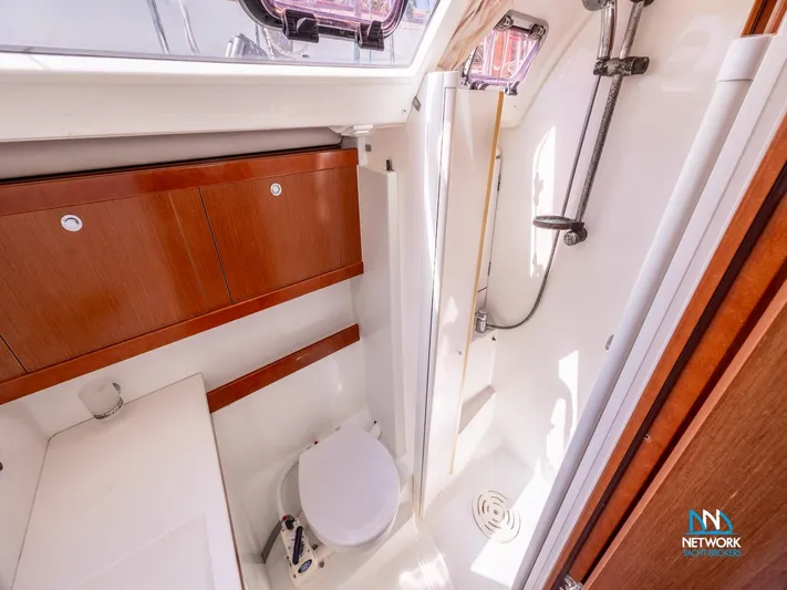  Yacht Photos Pics Beneteau Oceanis 46 bathroom interior, featuring shower and wooden cabinetry, 2011 model.