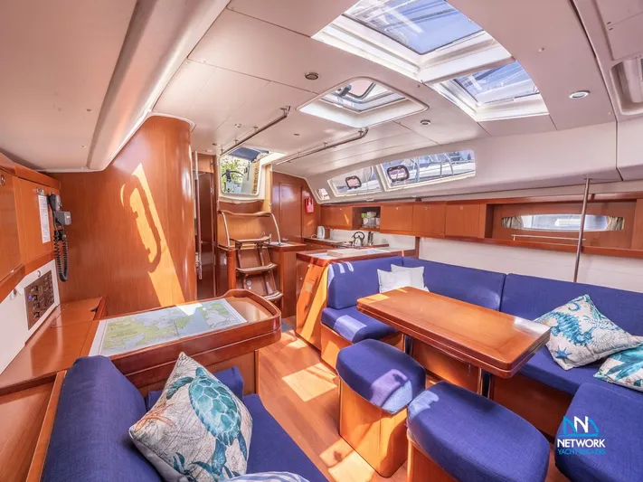  Yacht Photos Pics Interior of 2011 Beneteau Oceanis 46 yacht with blue seating and wooden finishes.