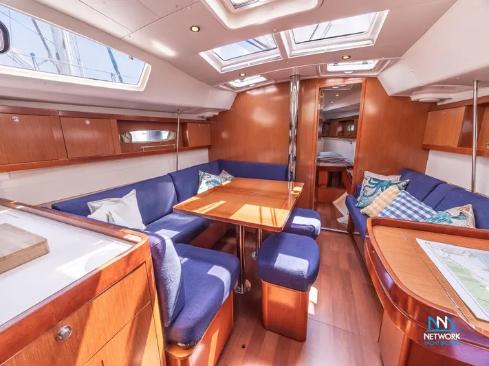  Yacht Photos Pics Interior of 2011 Beneteau Oceanis 46 yacht with cozy seating and wooden finishes.