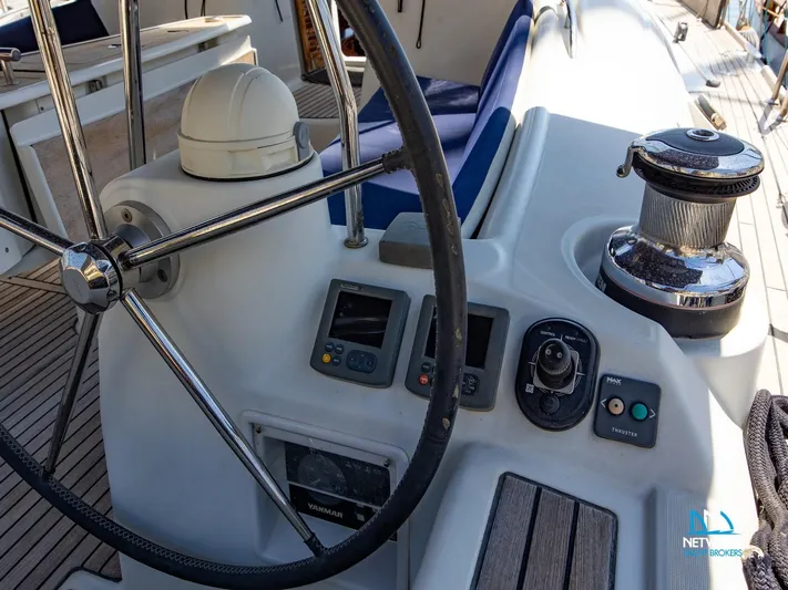  Yacht Photos Pics Cockpit of 2011 Beneteau Oceanis 46 sailboat with steering wheel and navigation controls.