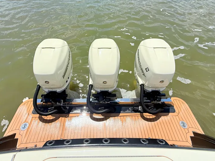 Wild Horses Yacht Photos Pics Triple Mercury outboard engines on 2020 Scout 380 LXF boat, docked on water.