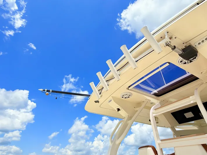 Wild Horses Yacht Photos Pics 2020 Scout 380 LXF boat against a bright blue sky with clouds.