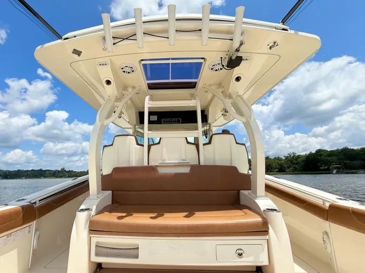 Wild Horses Yacht Photos Pics 2020 Scout 380 LXF boat interior with seating, under a clear blue sky.
