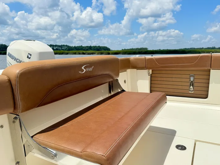 Wild Horses Yacht Photos Pics 2020 Scout 380 LXF boat interior with brown seating, under a blue sky.