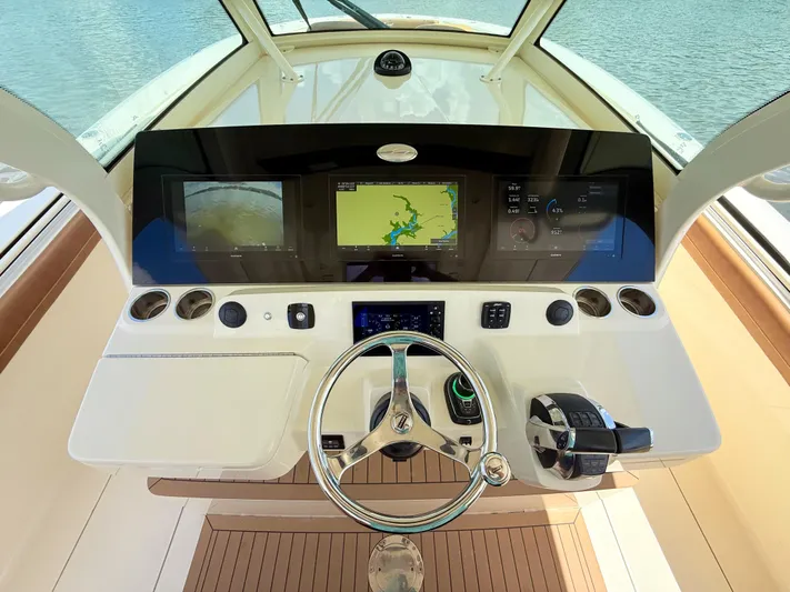 Wild Horses Yacht Photos Pics 2020 Scout 380 LXF boat dashboard with navigation screens and steering wheel.