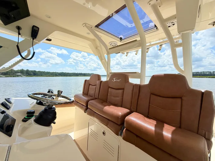 Wild Horses Yacht Photos Pics Luxurious interior of 2020 Scout 380 LXF boat with leather seating and scenic water view.