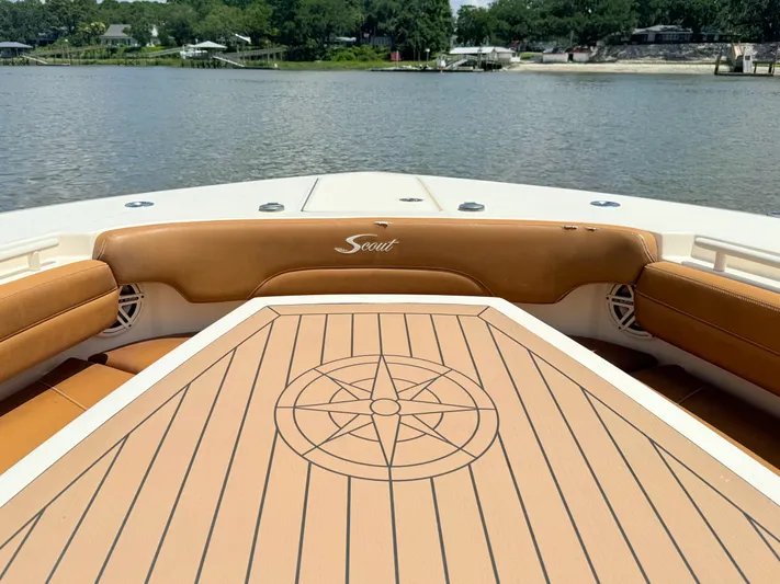 Wild Horses Yacht Photos Pics 2020 Scout 380 LXF boat interior with compass design table, overlooking serene water.