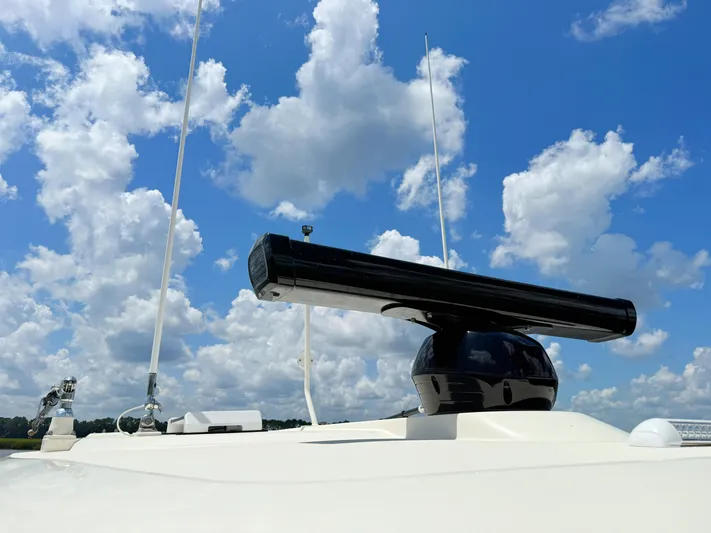 Wild Horses Yacht Photos Pics Radar equipment on 2020 Scout 380 LXF boat under a cloudy blue sky.