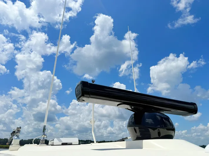 Wild Horses Yacht Photos Pics 2020 Scout 380 LXF boat radar against a bright blue sky with clouds.