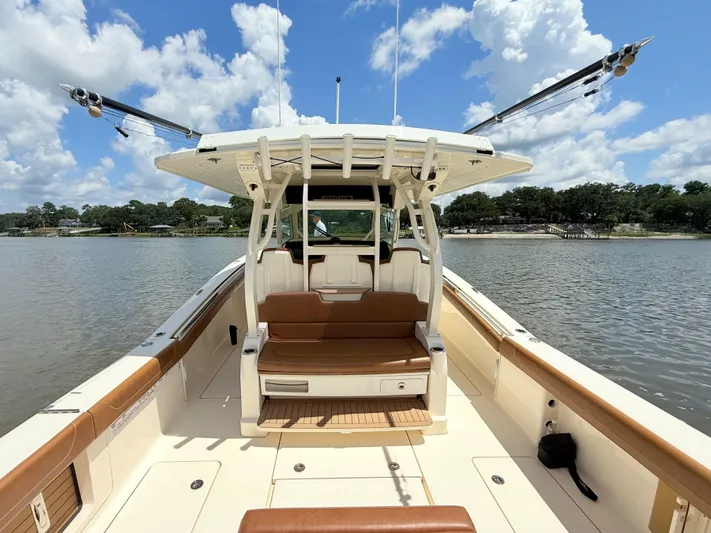 Wild Horses Yacht Photos Pics 2020 Scout 380 LXF boat on calm water under a blue sky.