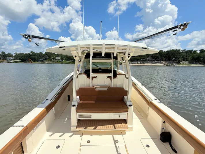 Wild Horses Yacht Photos Pics 2020 Scout 380 LXF boat on calm water under a cloudy sky.