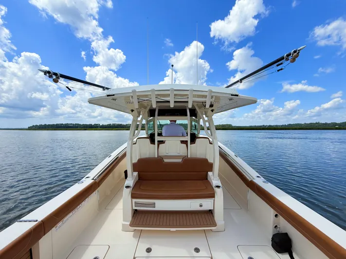 Wild Horses Yacht Photos Pics 2020 Scout 380 LXF boat on calm water under a blue sky with clouds.