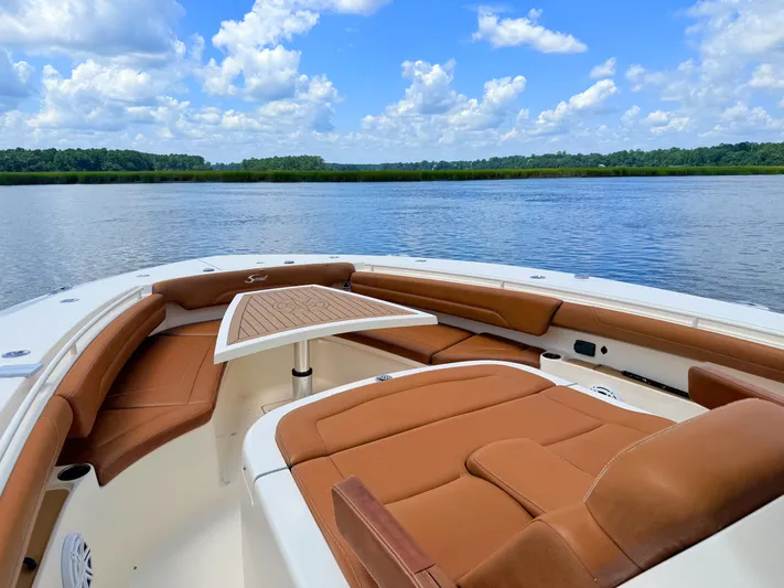 Wild Horses Yacht Photos Pics Luxurious 2020 Scout 380 LXF boat interior with tan seating, scenic water view.