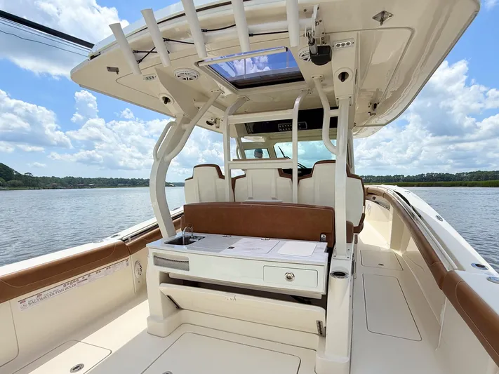 Wild Horses Yacht Photos Pics 2020 Scout 380 LXF boat interior with seating and helm, on a sunny day.