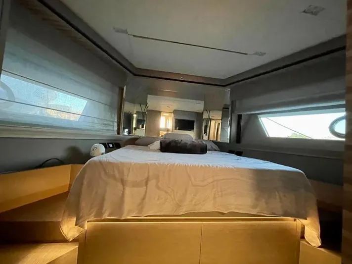  Yacht Photos Pics Luxurious bedroom interior of 2021 Ferretti Yachts 670 with modern design and ambient lighting.