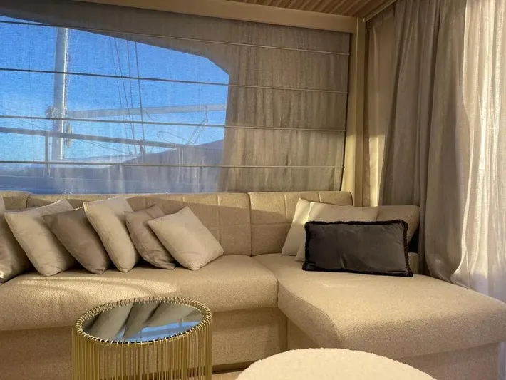  Yacht Photos Pics Luxurious interior of 2021 Ferretti Yachts 670 with elegant beige sofa and cushions.