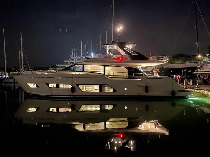  Yacht Photos Pics Luxury Ferretti Yachts 670, 2021 model, illuminated at night in marina.