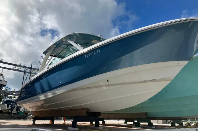  Yacht Photos Pics 2023 Boston Whaler 320 Vantage boat on display under a partly cloudy sky.