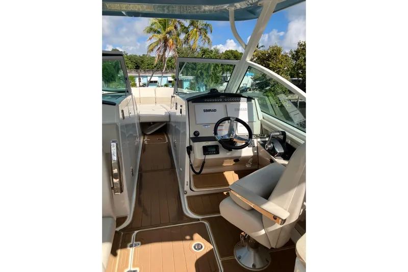  Yacht Photos Pics 2023 Boston Whaler 320 Vantage boat interior with helm, seating, and navigation equipment.