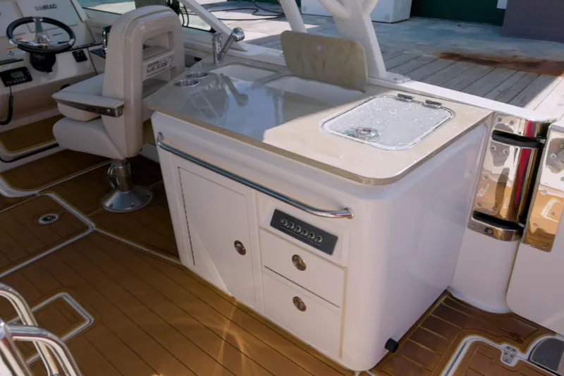  Yacht Photos Pics 2023 Boston Whaler 320 Vantage interior with helm and sink area.