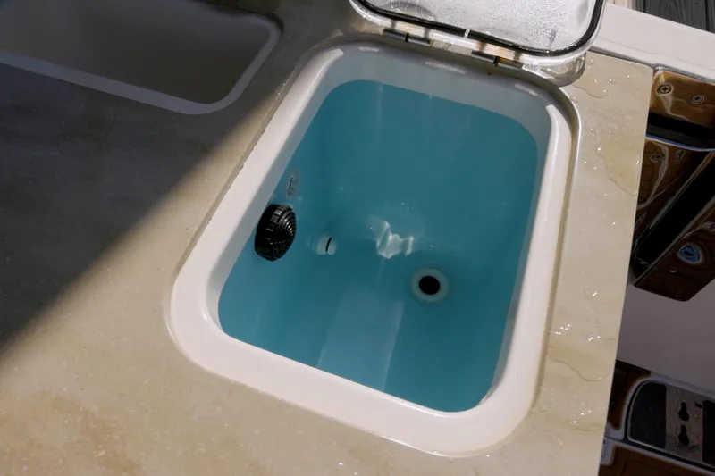  Yacht Photos Pics Livewell on 2023 Boston Whaler 320 Vantage boat, featuring blue interior and open lid.