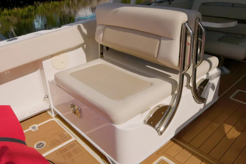  Yacht Photos Pics 2023 Boston Whaler 320 Vantage boat seating with beige cushions and stainless steel accents.