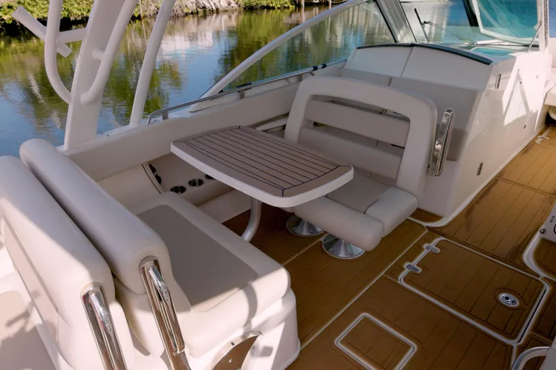  Yacht Photos Pics 2023 Boston Whaler 320 Vantage boat interior with seating and table on deck.