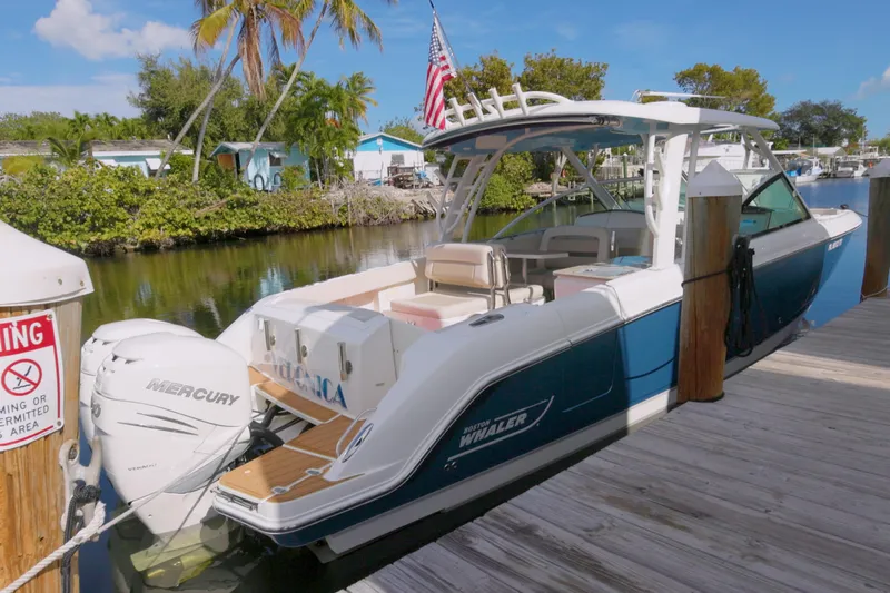 Yacht Photos Pics 2023 Boston Whaler 320 Vantage docked, featuring Mercury engines and sleek design.