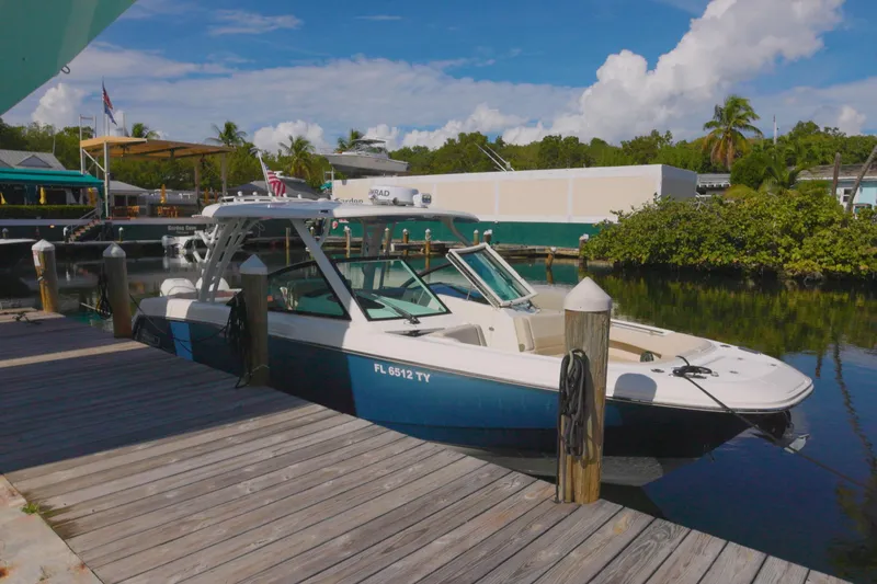  Yacht Photos Pics 2023 Boston Whaler 320 Vantage docked at a scenic marina.