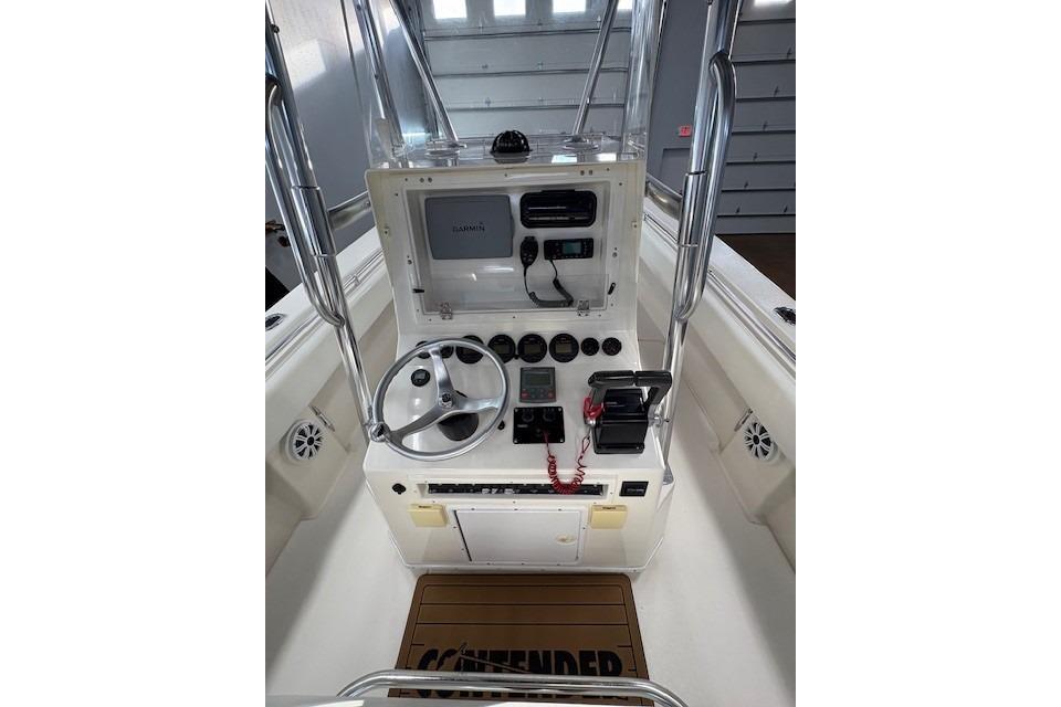 2003 Contender 27 Open boat console with steering wheel and navigation equipment.