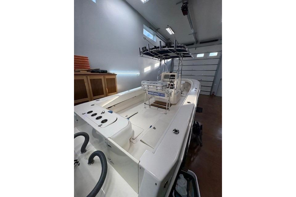 2003 Contender 27 Open boat in a garage, showcasing spacious deck and modern design.
