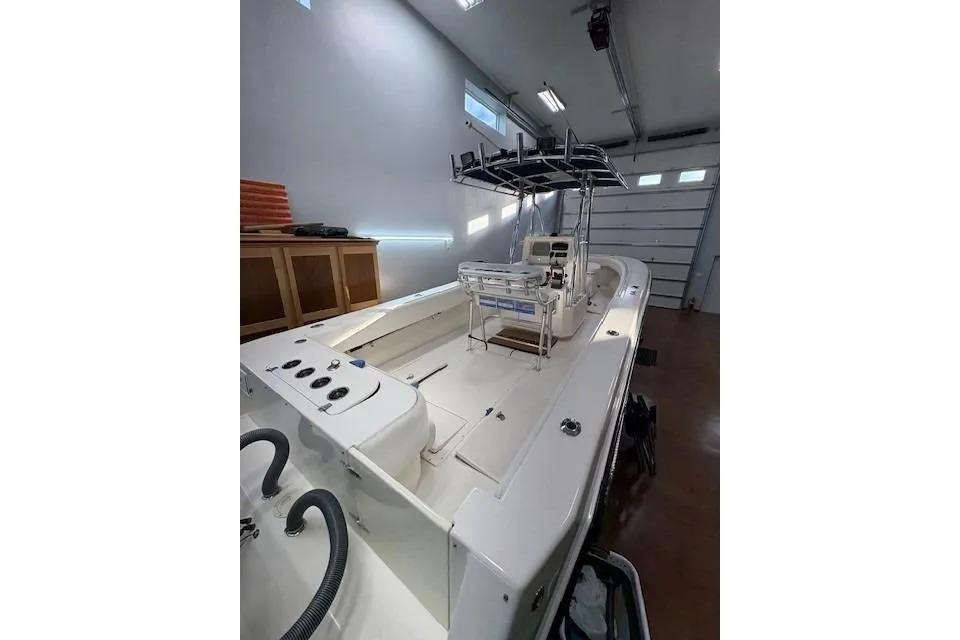 2003 Contender 27 Open boat in a garage, showcasing spacious deck and modern design.