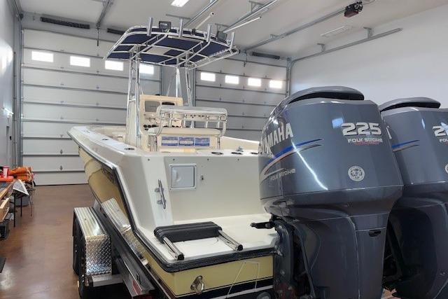 2003 Contender 27 Open boat with dual Yamaha 225 engines in a garage.