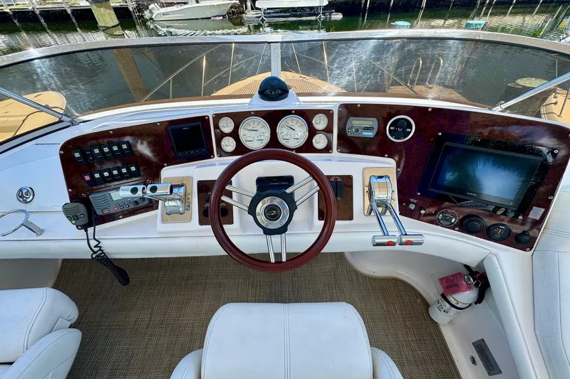 Santa Josefina Yacht Photos Pics Cockpit of 2009 Regal 4080 yacht with steering wheel, gauges, and navigation controls.
