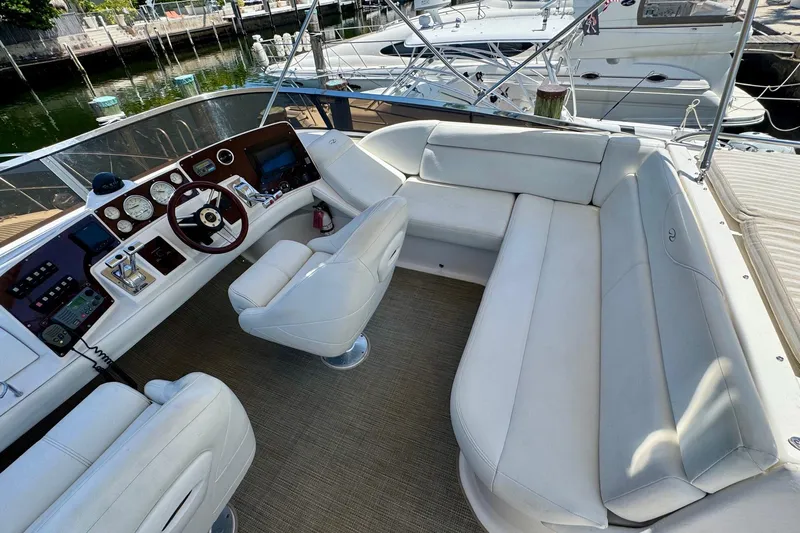 Santa Josefina Yacht Photos Pics Luxurious 2009 Regal 4080 yacht interior with white seating and modern dashboard.