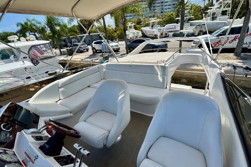 Santa Josefina Yacht Photos Pics Luxurious 2009 Regal 4080 yacht interior with white seating and modern helm.