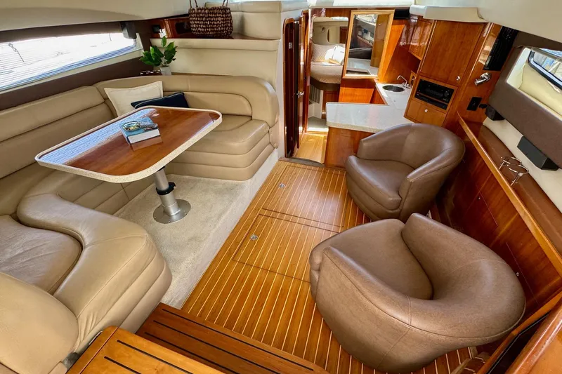 Santa Josefina Yacht Photos Pics Luxurious interior of a 2009 Regal 4080 yacht with elegant seating and wooden flooring.