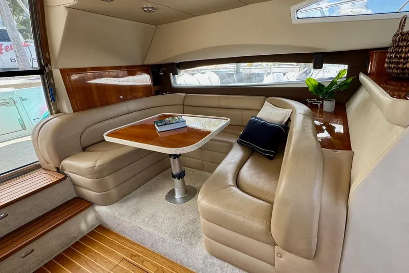 Santa Josefina Yacht Photos Pics Luxurious interior of a 2009 Regal 4080 yacht with plush seating and elegant table.