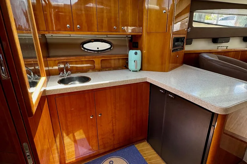 Santa Josefina Yacht Photos Pics Luxurious 2009 Regal 4080 yacht kitchen with wood cabinetry and modern appliances.