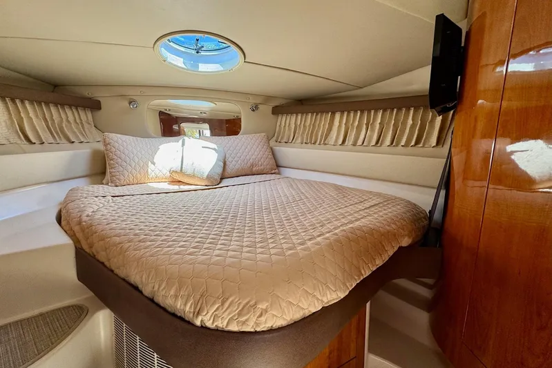 Santa Josefina Yacht Photos Pics Luxurious cabin interior of 2009 Regal 4080 yacht with cozy bed and elegant decor.